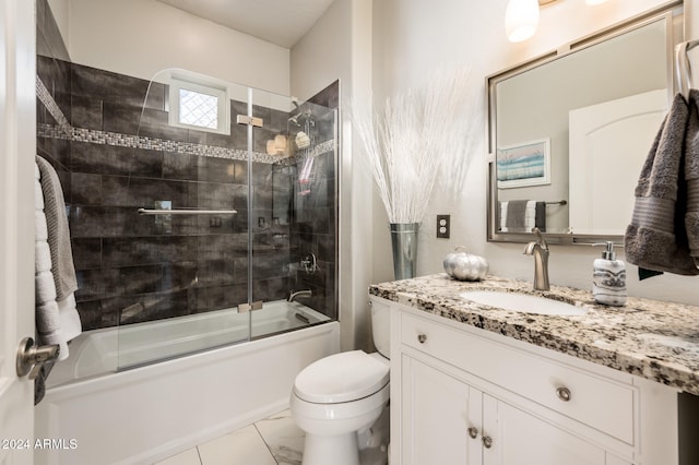 full bathroom featuring toilet, vanity, and shower / bath combination with glass door