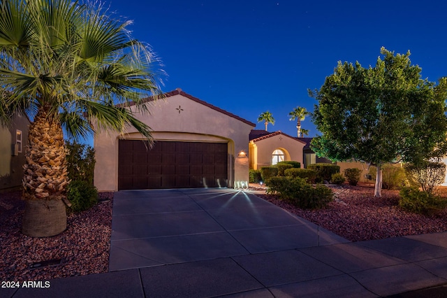 mediterranean / spanish-style home featuring a garage