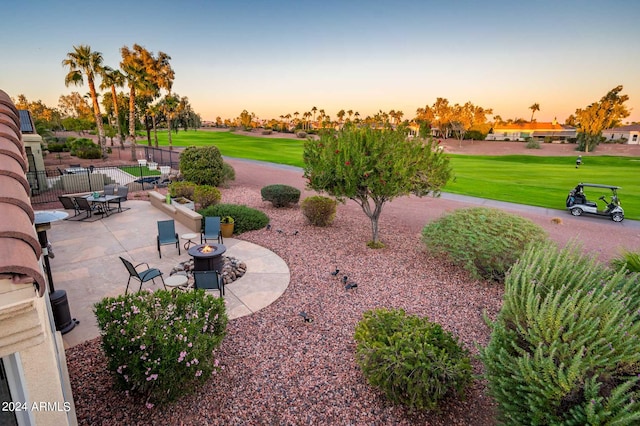 yard at dusk featuring a patio area