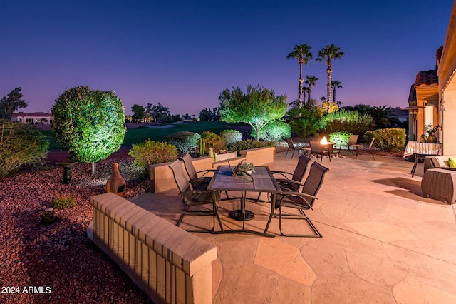 view of patio terrace at dusk