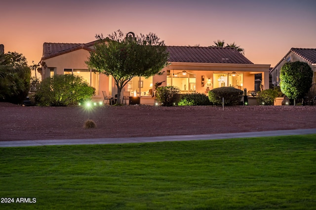 mediterranean / spanish house featuring a lawn