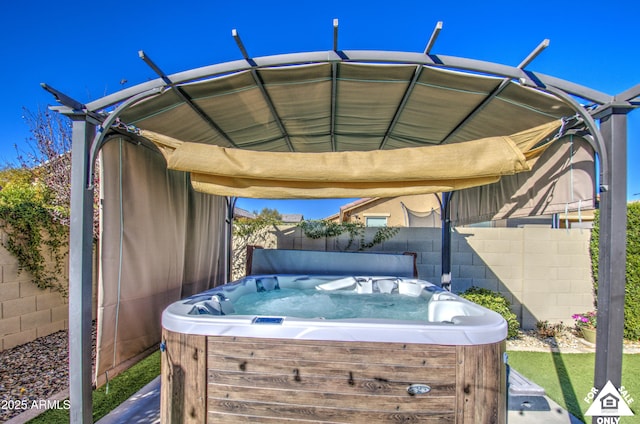 view of patio / terrace with a hot tub