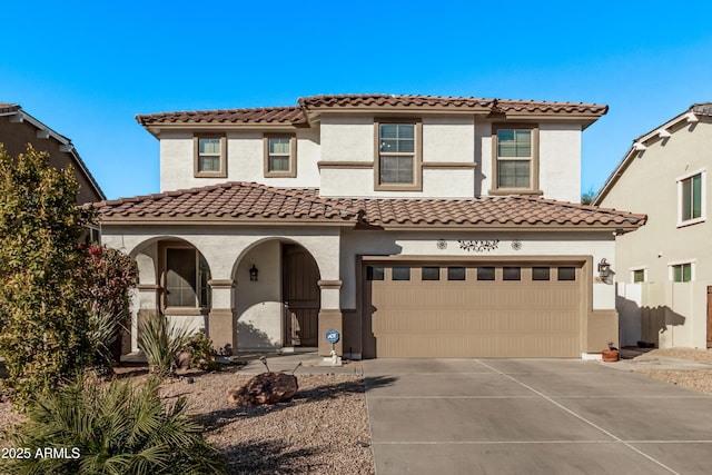 mediterranean / spanish-style home with a garage