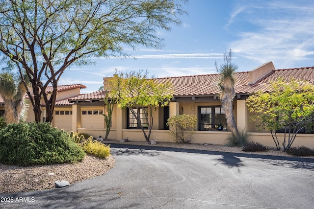 mediterranean / spanish house featuring a garage