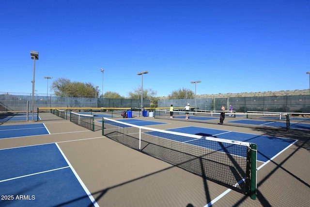 view of tennis court featuring fence