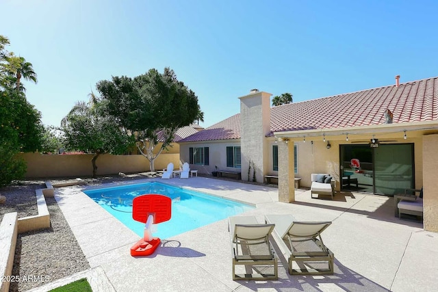 view of pool with a fenced in pool, a patio, a ceiling fan, and a fenced backyard