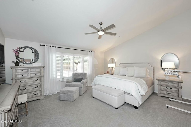 bedroom with vaulted ceiling, a ceiling fan, and carpet floors