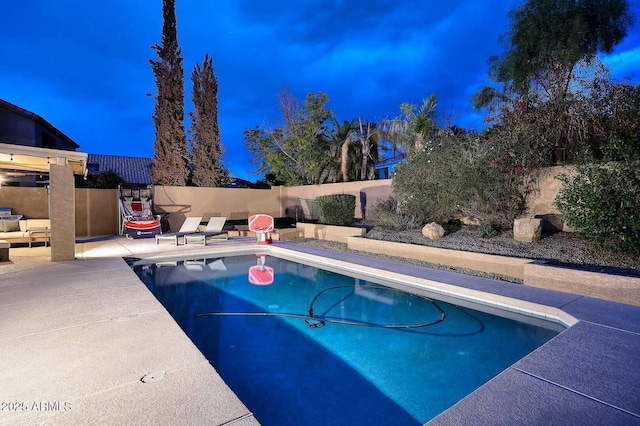 view of swimming pool featuring a patio, fence, and a fenced in pool