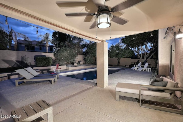 view of patio / terrace featuring a fenced in pool, a fenced backyard, and a ceiling fan