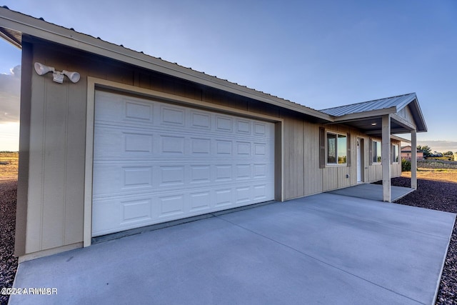 view of garage at dusk