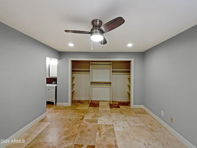 unfurnished bedroom with a closet, recessed lighting, connected bathroom, and baseboards