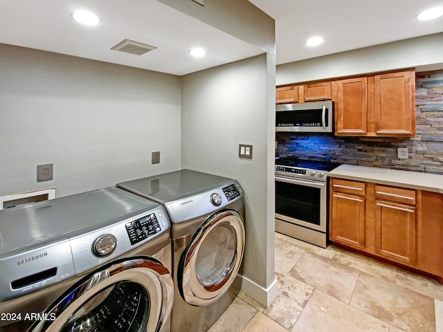 laundry area featuring recessed lighting, visible vents, laundry area, and washing machine and clothes dryer