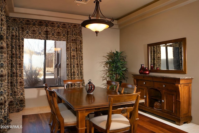 dining space with hardwood / wood-style floors