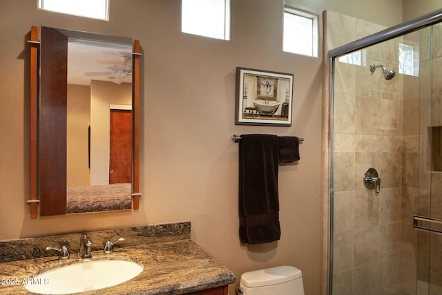 bathroom featuring vanity, toilet, and an enclosed shower