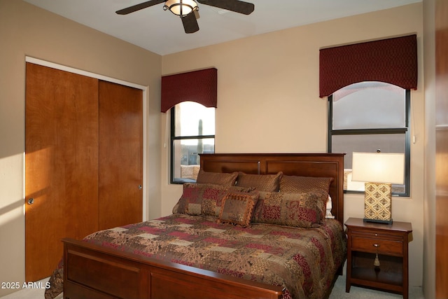 bedroom with ceiling fan and a closet