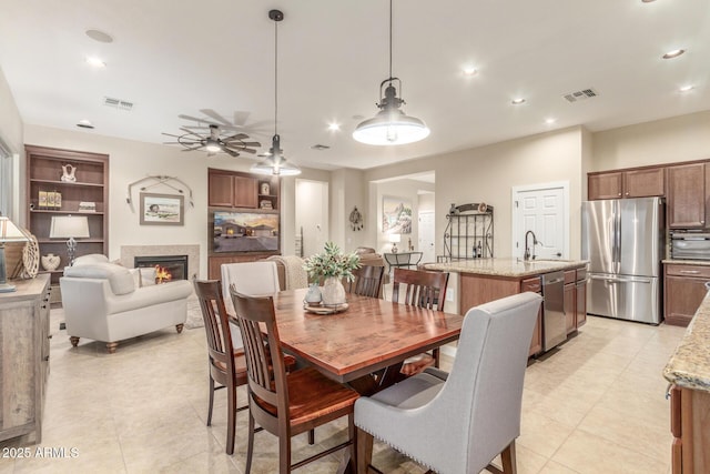 13102 S 177th Dr, Goodyear, AZ 85338 - dining area with light tile patterned flooring, ceiling fan, sink, and built in features