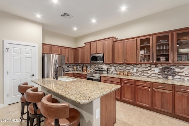 13102 S 177th Dr, Goodyear, AZ 85338 - kitchen with sink, a kitchen breakfast bar, an island with sink, and appliances with stainless steel finishes