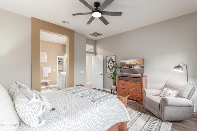 13102 S 177th Dr, Goodyear, AZ 85338 - bedroom with ceiling fan, wood-type flooring, and connected bathroom