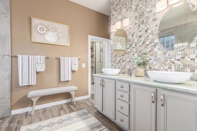 13102 S 177th Dr, Goodyear, AZ 85338 - bathroom featuring tasteful backsplash, vanity, and hardwood / wood-style floors