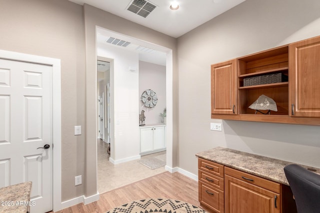 13102 S 177th Dr, Goodyear, AZ 85338 - office space featuring light hardwood / wood-style flooring and built in desk