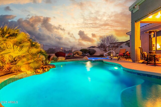 13102 S 177th Dr, Goodyear, AZ 85338 - pool at dusk featuring a patio