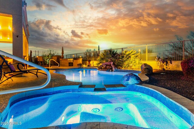 13102 S 177th Dr, Goodyear, AZ 85338 - pool at dusk featuring an in ground hot tub