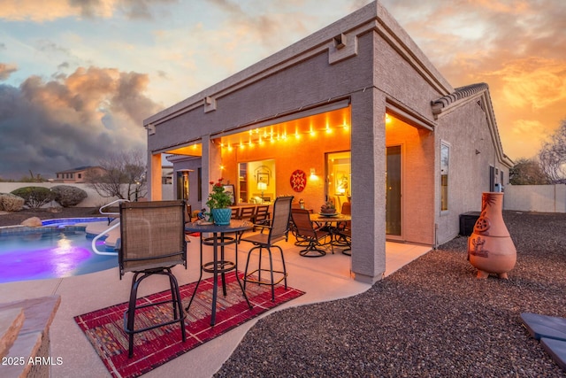 13102 S 177th Dr, Goodyear, AZ 85338 - patio terrace at dusk featuring a fenced in pool