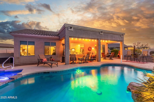 13102 S 177th Dr, Goodyear, AZ 85338 - pool at dusk with an in ground hot tub and a patio area