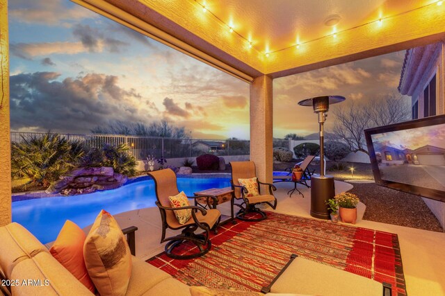 13102 S 177th Dr, Goodyear, AZ 85338 - patio terrace at dusk featuring a fenced in pool
