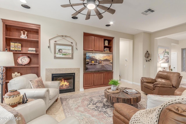 13102 S 177th Dr, Goodyear, AZ 85338 - living room with a tile fireplace, ceiling fan, and built in shelves