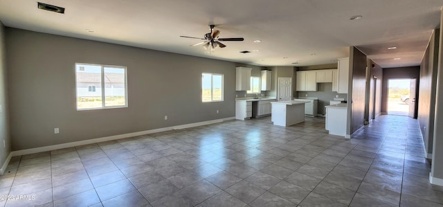 interior space featuring ceiling fan, sink, and light tile floors