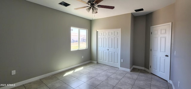 unfurnished bedroom with ceiling fan and light tile floors