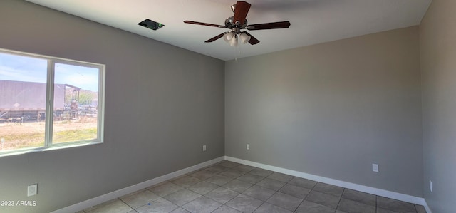 tiled empty room with ceiling fan