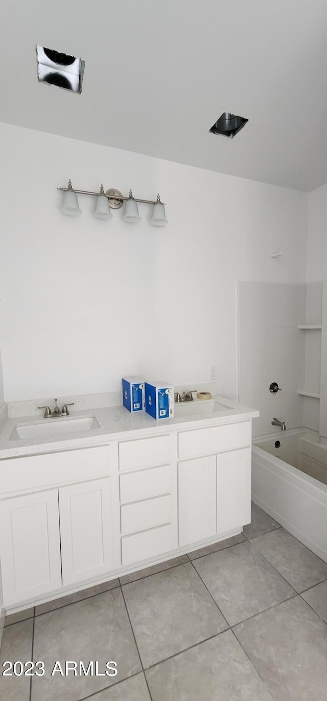 bathroom featuring double vanity, washtub / shower combination, and tile flooring