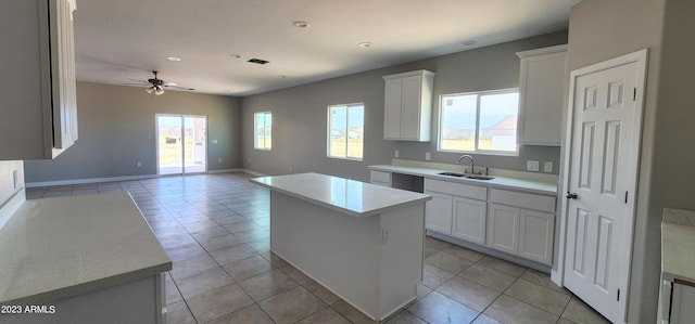 kitchen with white cabinets, a center island, and a wealth of natural light