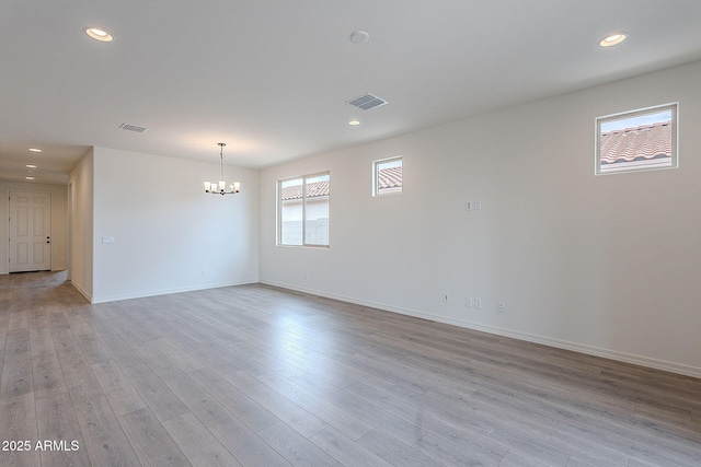 empty room featuring recessed lighting, visible vents, and an inviting chandelier