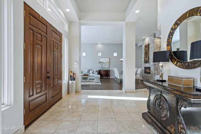 foyer with a fireplace and light hardwood / wood-style floors