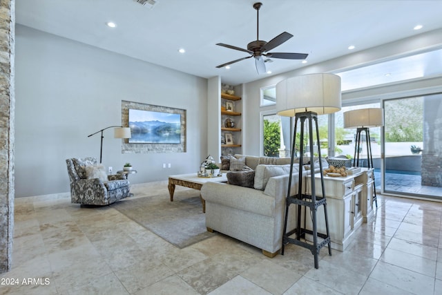 living room with ceiling fan and built in features