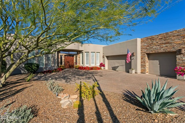 pueblo revival-style home with a garage