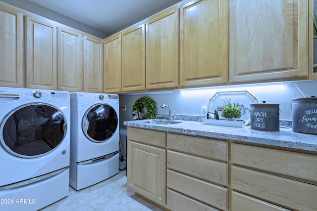 washroom featuring cabinets, light tile patterned floors, separate washer and dryer, and sink