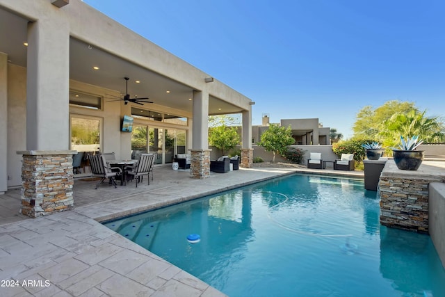 view of swimming pool featuring a patio area and ceiling fan