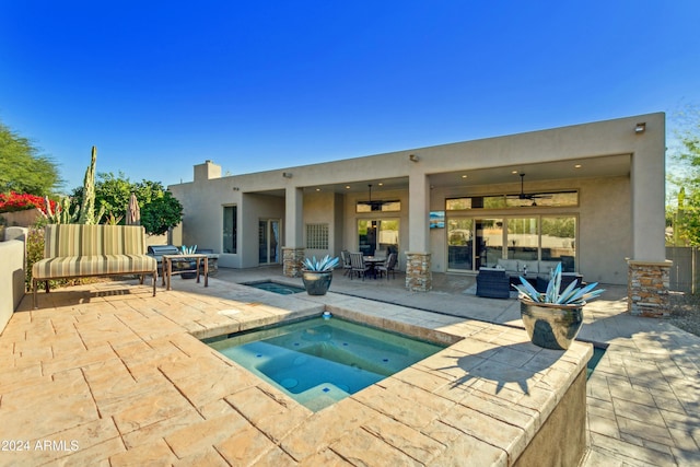 view of pool with ceiling fan, an outdoor living space, an in ground hot tub, and a patio