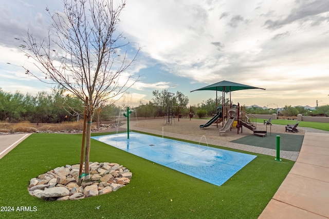 view of jungle gym featuring a lawn