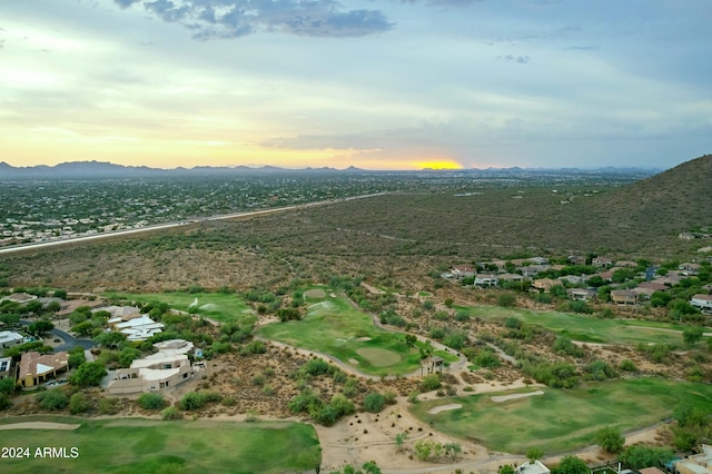 aerial view at dusk featuring a mountain view