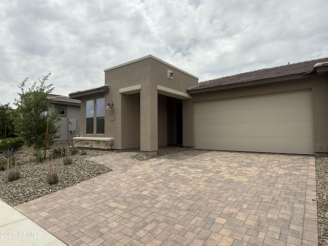 4053 Desert Moon Dr, Wickenburg, AZ 85390 - view of front of property featuring stucco siding, decorative driveway, and a garage