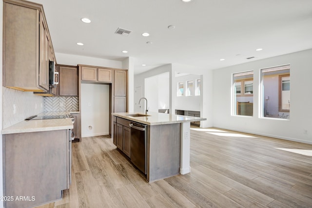 4053 Desert Moon Dr, Wickenburg, AZ 85390 - kitchen with stainless steel appliances, light countertops, light wood-style flooring, recessed lighting, and decorative backsplash
