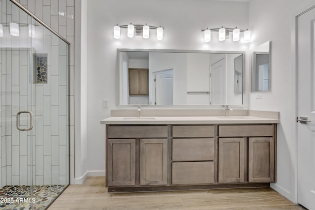 4053 Desert Moon Dr, Wickenburg, AZ 85390 - full bathroom featuring a stall shower, double vanity, and wood finished floors