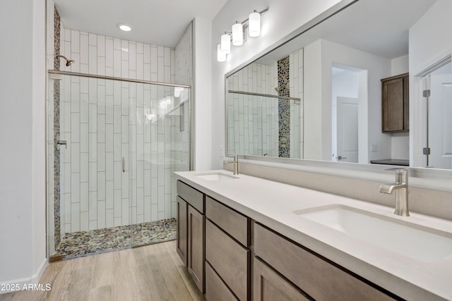 4053 Desert Moon Dr, Wickenburg, AZ 85390 - full bathroom featuring a stall shower, double vanity, wood finished floors, and recessed lighting
