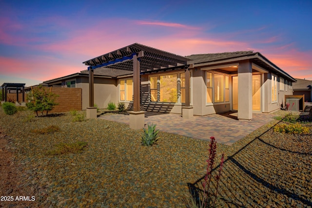 4053 Desert Moon Dr, Wickenburg, AZ 85390 - rear view of property featuring stucco siding, a pergola, a patio area, and a tiled roof