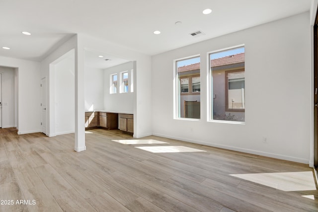 4053 Desert Moon Dr, Wickenburg, AZ 85390 - unfurnished living room with light wood-style flooring and recessed lighting